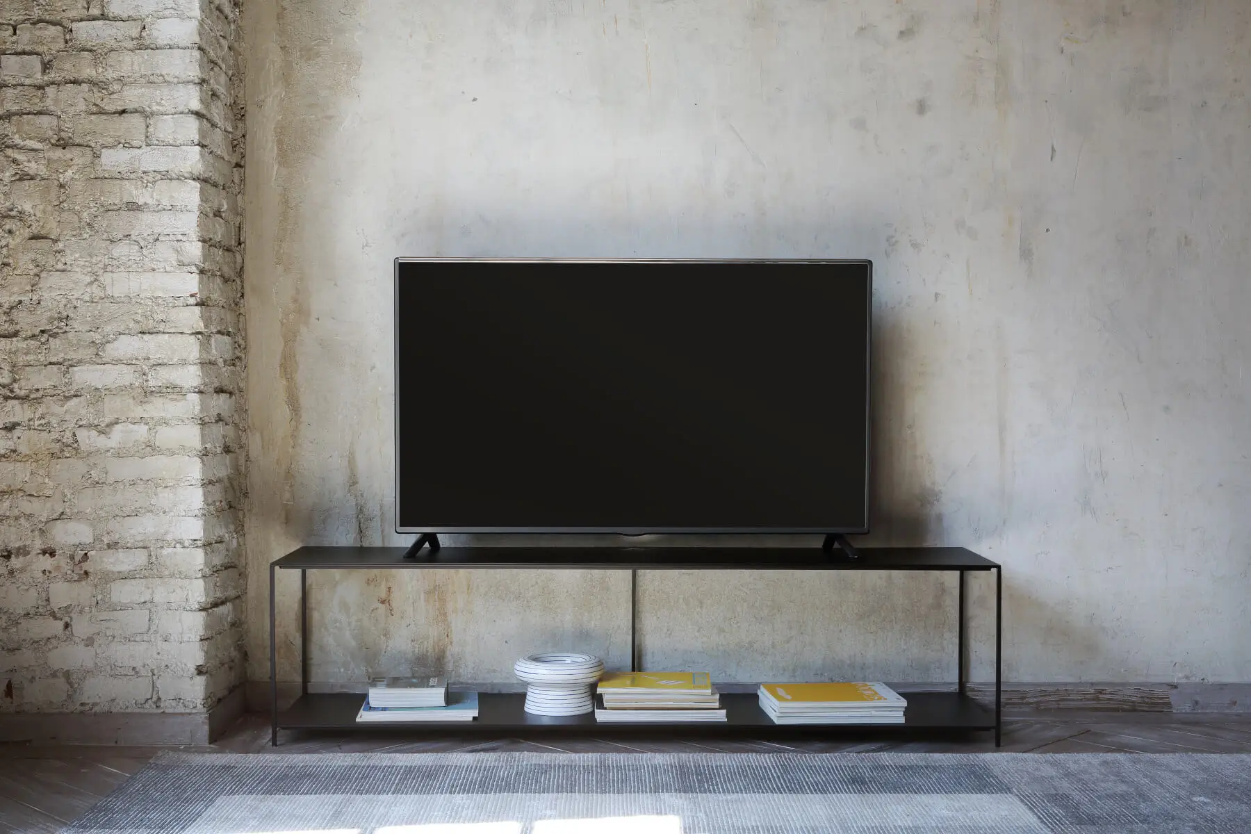 Zeus Slim Irony TV Konsolentisch als minimalistisches TV-Möbel im Wohnzimmer mit offener Ablage für Bücher und Wohnaccessoires.