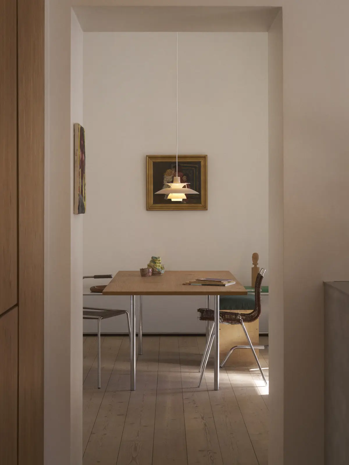Louis Poulsen PH 5 320 Opal Pendelleuchte in Beige über einem Esstisch im modernen Wohnambiente