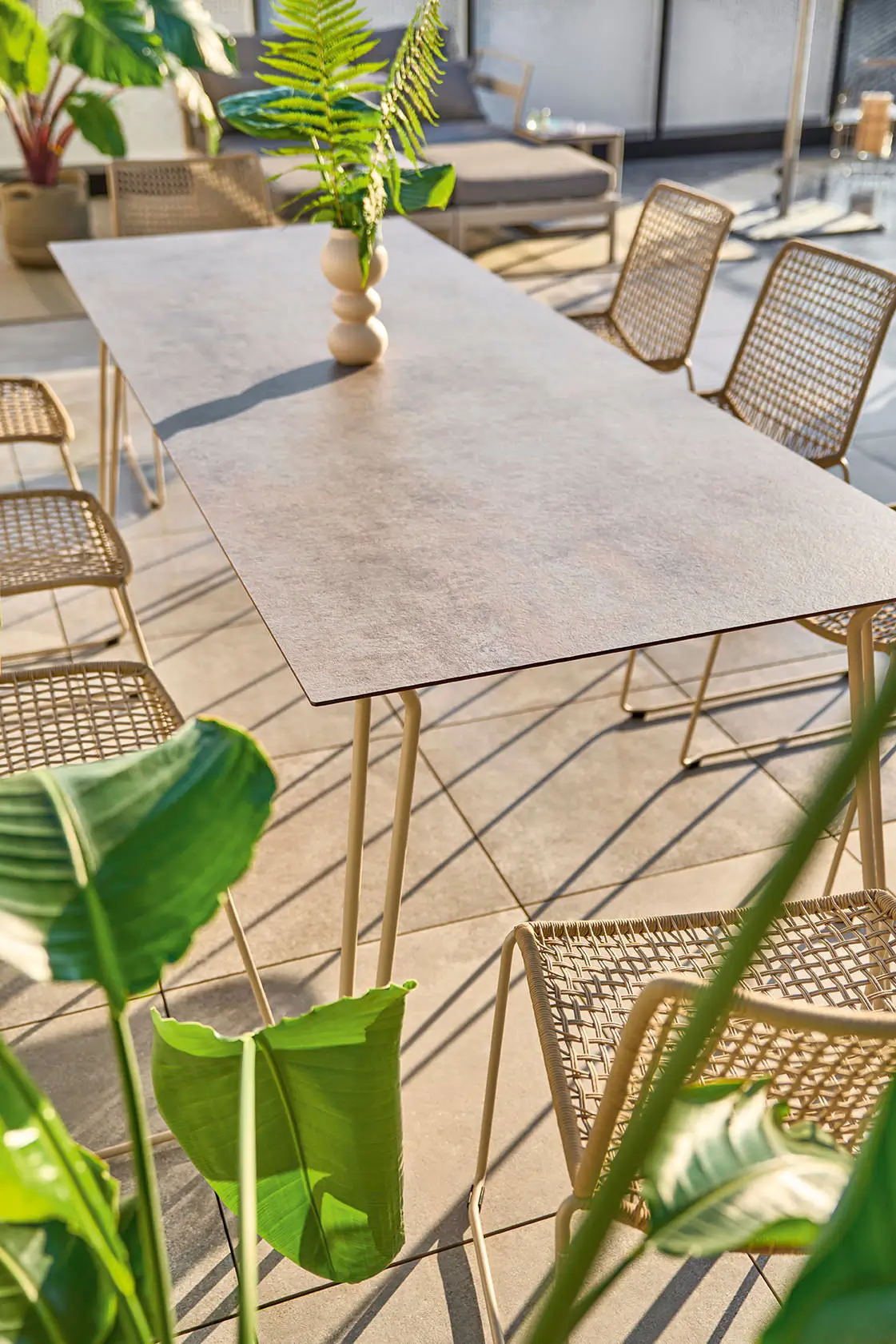 Detailaufnahme des Weishäupl Slope Tisches mit HPL-Steinplatte und perlbeigem Gestell. Wetterfester Design-Gartentisch für Terrasse und Außenbereich.