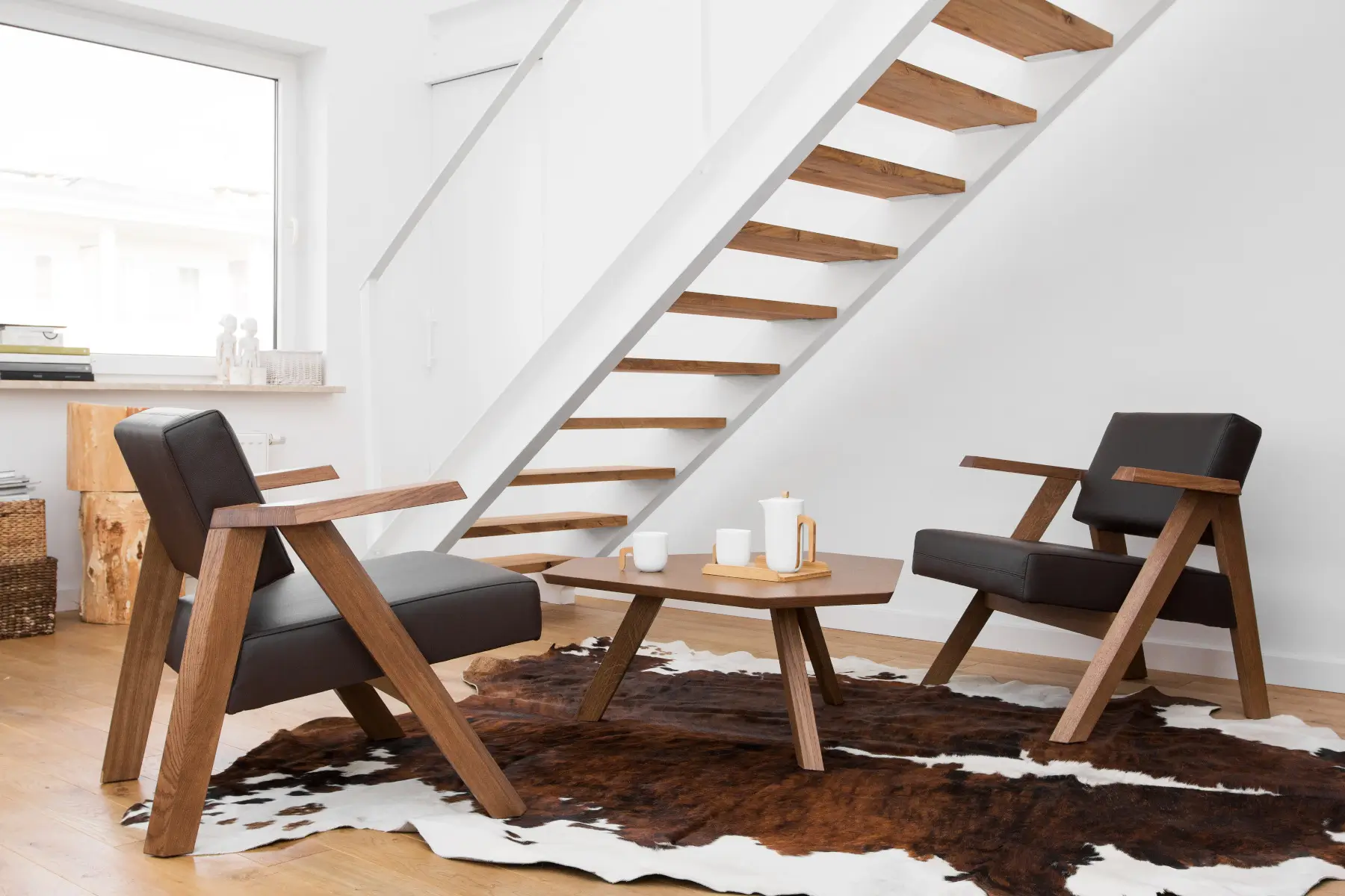 Zwei Noti Clapp Sessel in Braun mit Holzgestell und Armlehnen in einer modernen Sitzgruppe